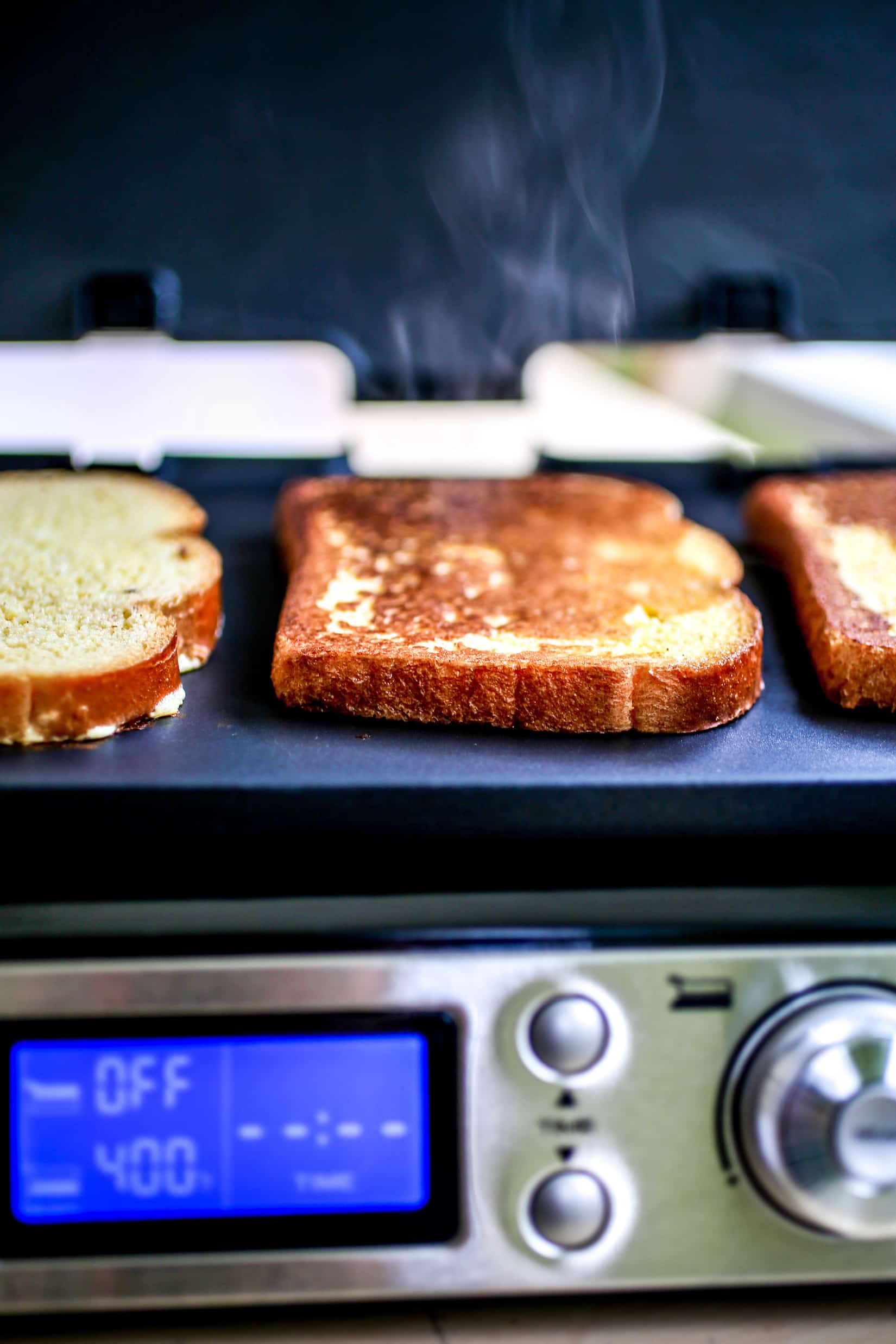 French toast cooking on a griddle.