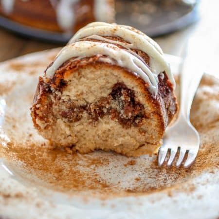 Cinnamon Roll Bundt Cake - From the gooey cinnamon swirl, to the iconic cream cheese icing on top, this Cinnamon Roll Bundt Cake is perfection for cinnamon roll lovers.