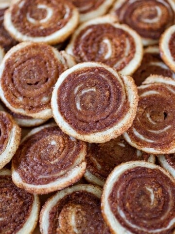 Cinnamon Sugar Puff Pastry Cookies - Puff pastry dough is rolled up in a sweet and spicy coating of cinnamon sugar, sliced into cookies and baked up to golden perfection!