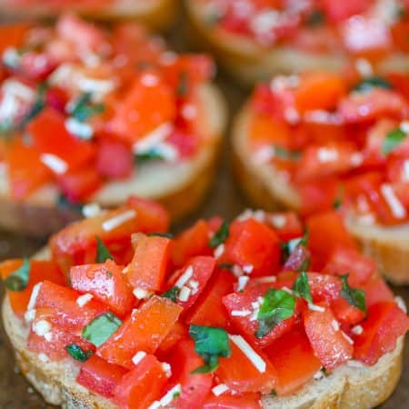 Bruschetta on top of toasted baguette slice.