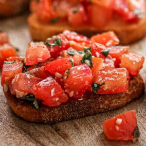 Easy bruschetta on a piece of crostini.