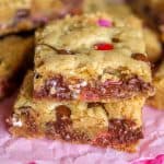 M&M Chocolate chip cookie bars stacked in two on top of one another.