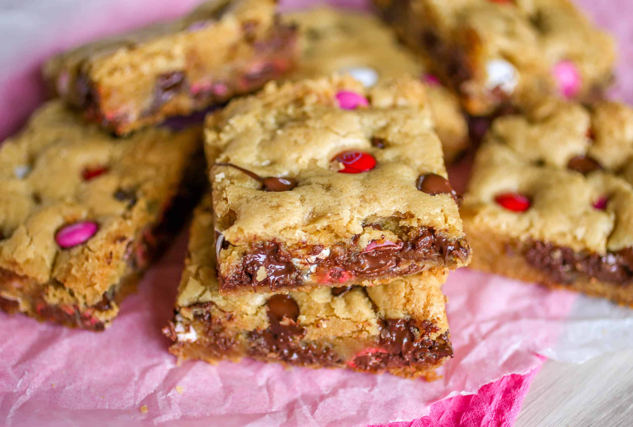 Soft and Chewy Chocolate Chip M&M Cookie Bars - These chewy chocolate chip M&M cookie bars are just the cookie fix you're looking for! Soft, chewy and chock full of chocolate. And no dough chilling required!