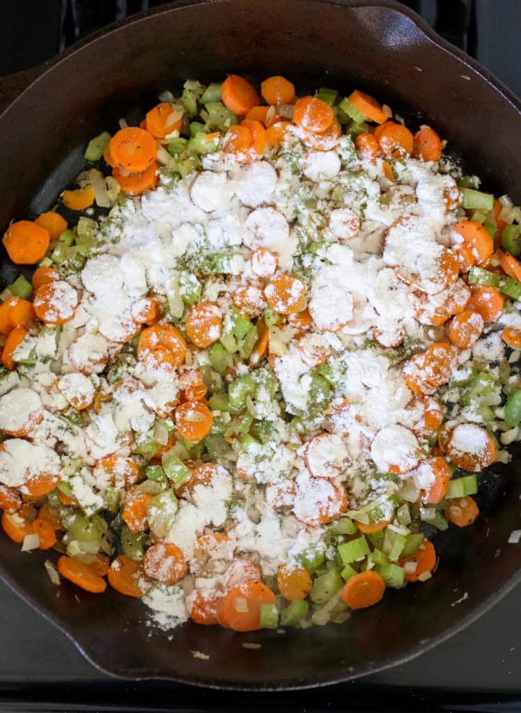 Flour sprinkled on top of sautéed carrots, celery and onion.