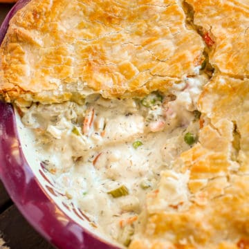 Whole chicken pot pie with slice missing.