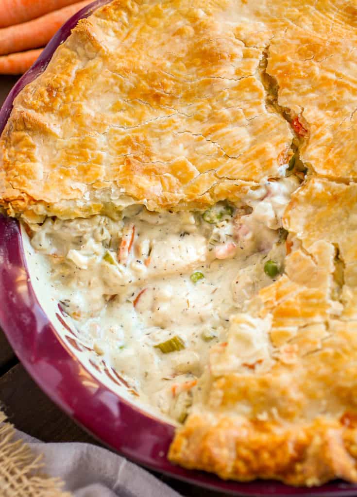 Whole chicken pot pie with slice missing.