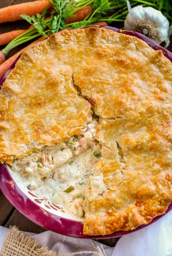 Whole chicken pot pie with slice missing.