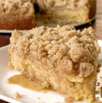 Apple Crumb Coffee Cake on a plate with caramel oozing out.