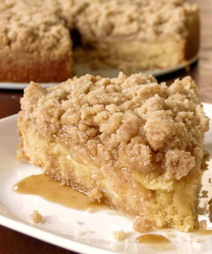 Apple Crumb Coffee Cake on a plate with caramel oozing out.