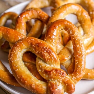 Baked soft pretzels on plate.