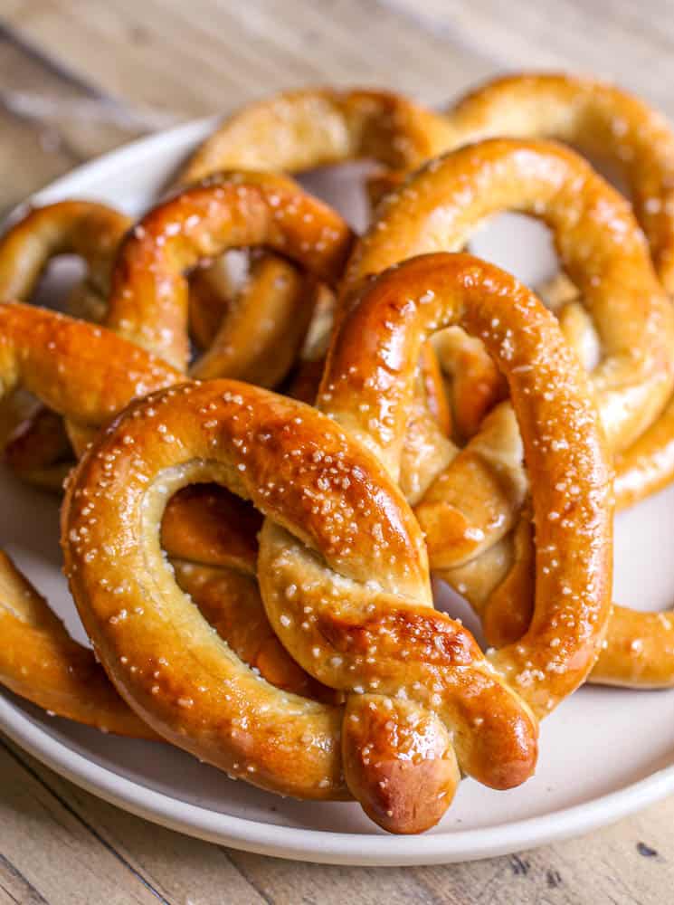 Baked soft pretzels on plate.