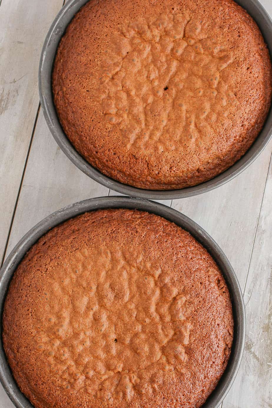Carrot cakes fresh out of the oven in baking pans.
